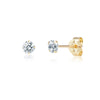 Gold stud earrings with clear gemstones on a white background