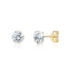 Gold stud earrings with clear gemstones on a white background
