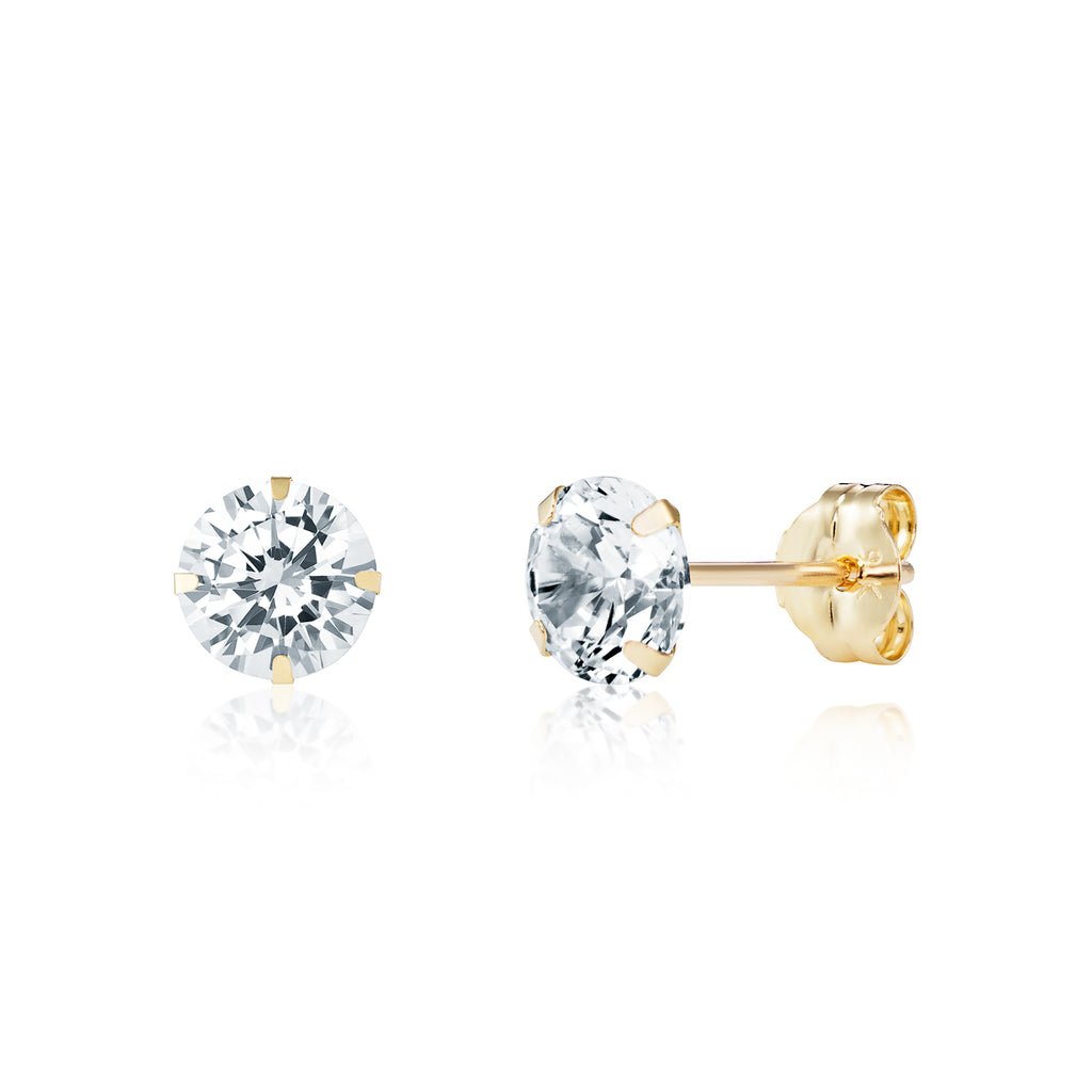 Gold stud earrings with clear gemstones on a white background