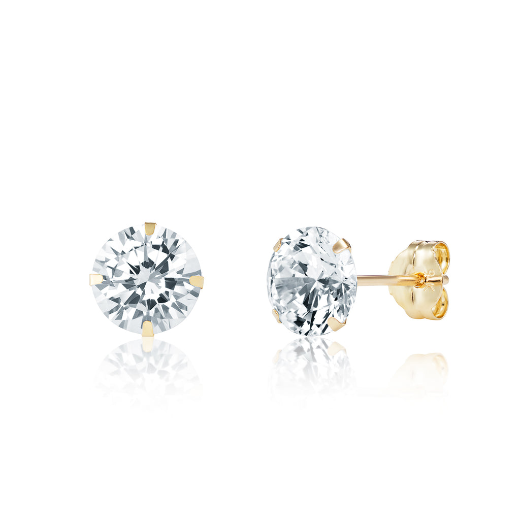 Gold stud earrings with clear gemstones on a white background