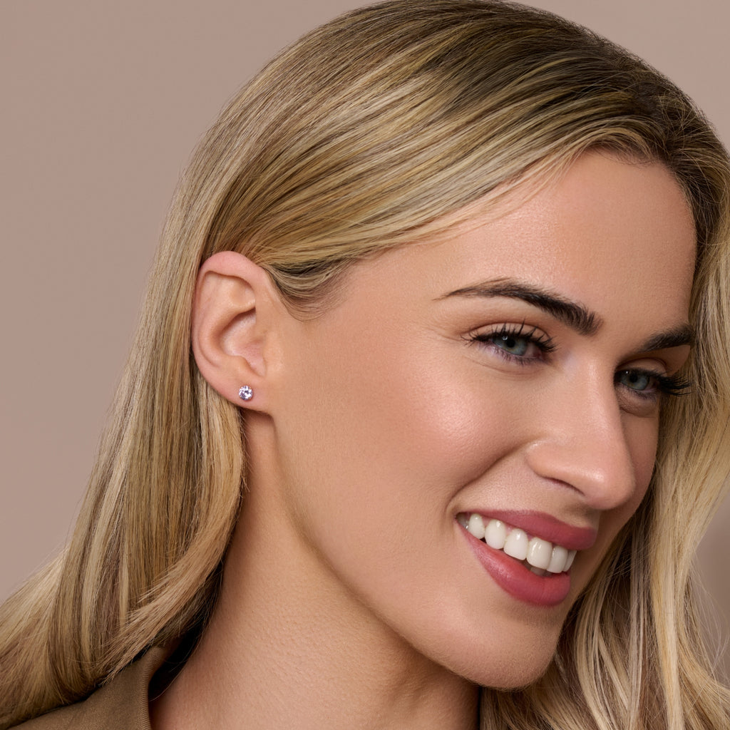 A pair of 9ct gold stud earrings with a pink octagonal-shaped tourmaline gemstone in the center.