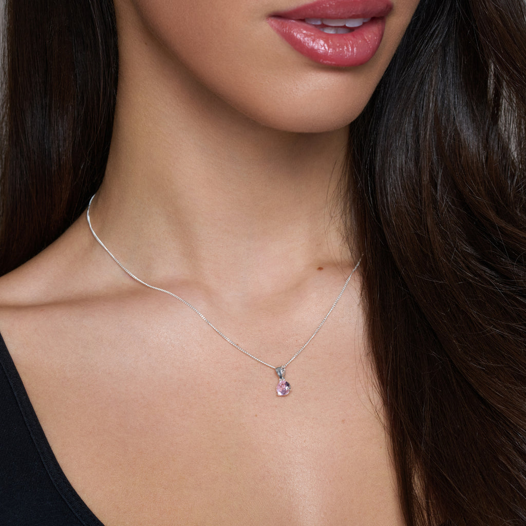 Necklace with a pink pendant on a white background