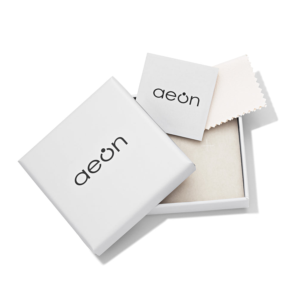 Silver earrings with heart-shaped gemstones on a white background