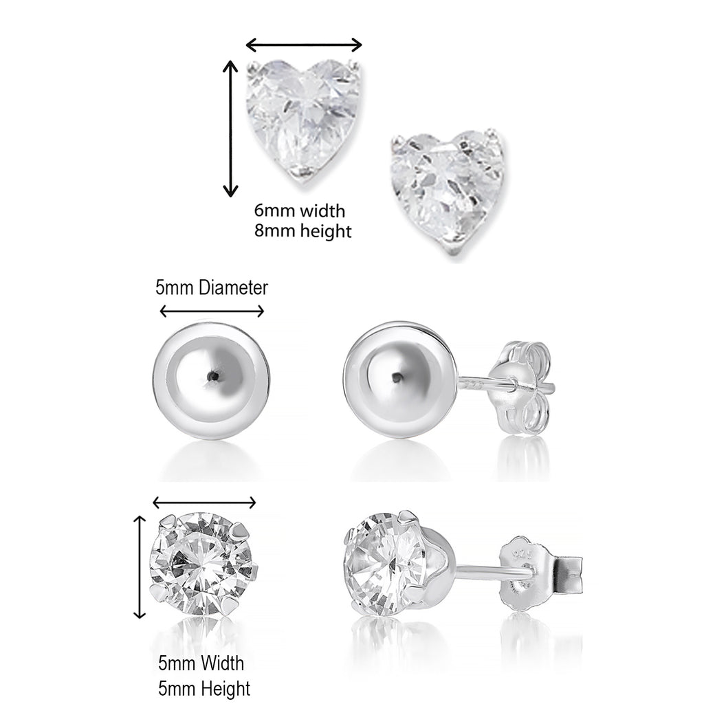 A set of three pairs of sterling silver stud earrings, featuring different designs including heart, round, and teardrop shapes, adorned with clear cubic zircona stones.
