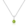Green gemstone pendant on a silver chain against a white background