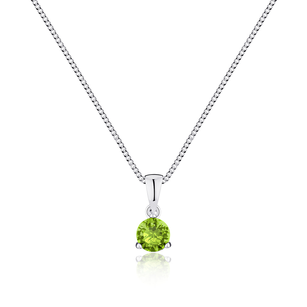 Green gemstone pendant on a silver chain against a white background