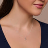Silver necklace with a letter 'E' pendant worn by a model against a neutral background